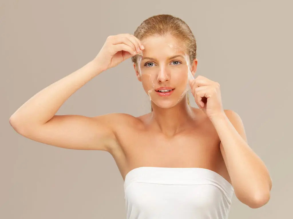 Woman peals off clear facemask