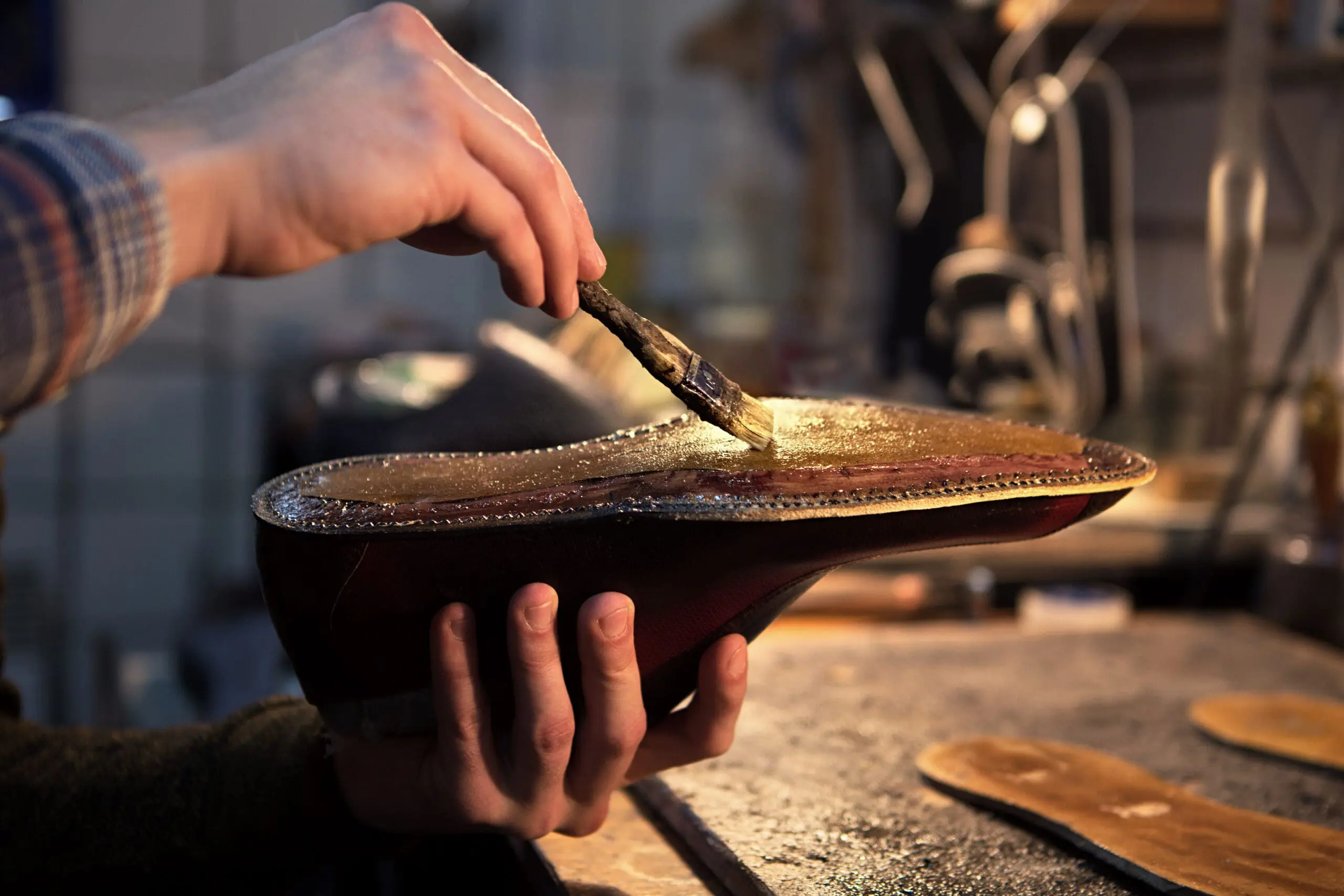 Shoemaker applies varnish to the bottom of a shoe. Kraton's polymers and pine chemicals are often used in the formulation of adhesives and sealants for a variety of industrial uses.