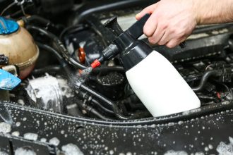 Washing a car engine with a cleaner made with SYLVASOLV biobased chemicals for industrial defoamers.