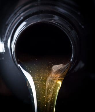 Oil-based fuel additive being poured