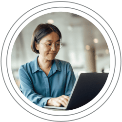 Terms of Use: Asian woman looking at a computer screen and smiling